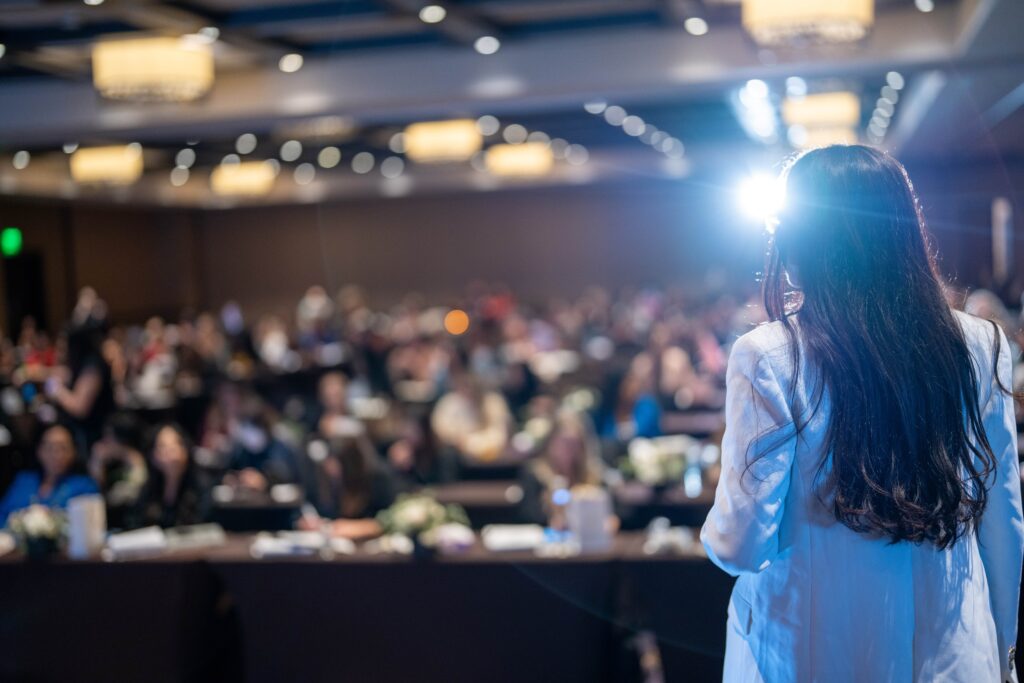 Mrs. Linda Paradis is at the stage as a speaker at Las Vegas PMU Conference 2023 USA